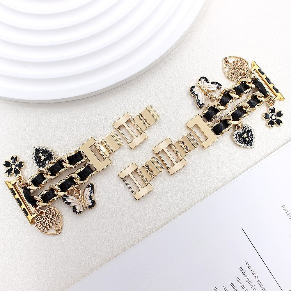 EIDERWOOD Apple Watch (38 / 40 / SE / 41 / 42mm) Metall Rem m. Kunstskinn & Vedheng - Gull / Svart