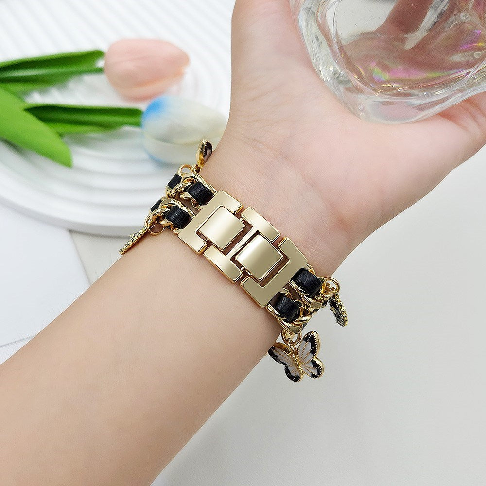 EIDERWOOD Apple Watch (38 / 40 / SE / 41 / 42mm) Metall Rem m. Kunstskinn & Vedheng - Gull / Svart